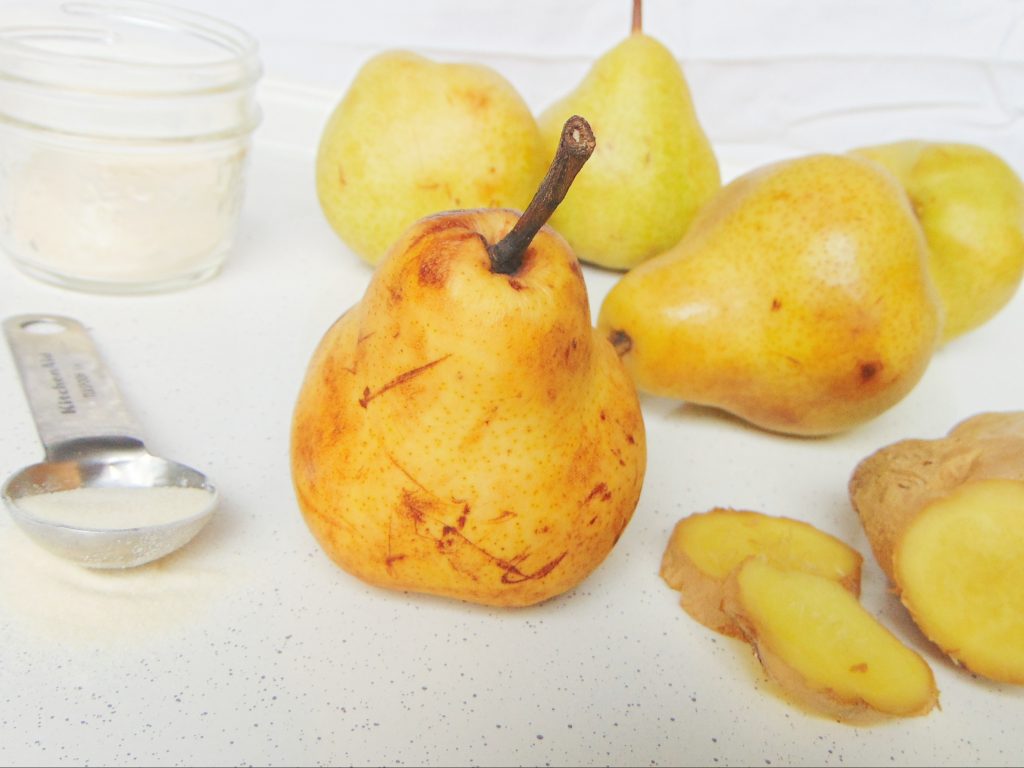Pears, ginger and gelatin powder on white background