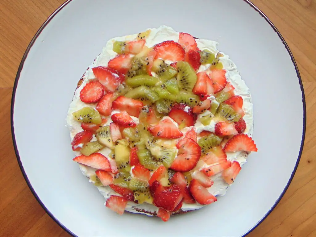 Coconut flour birthday cake filling with whipped cream, strawberries and kiwis
