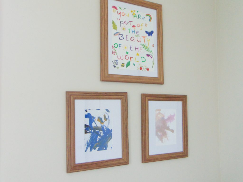 Three framed pictures in minimalist kid's bedroom