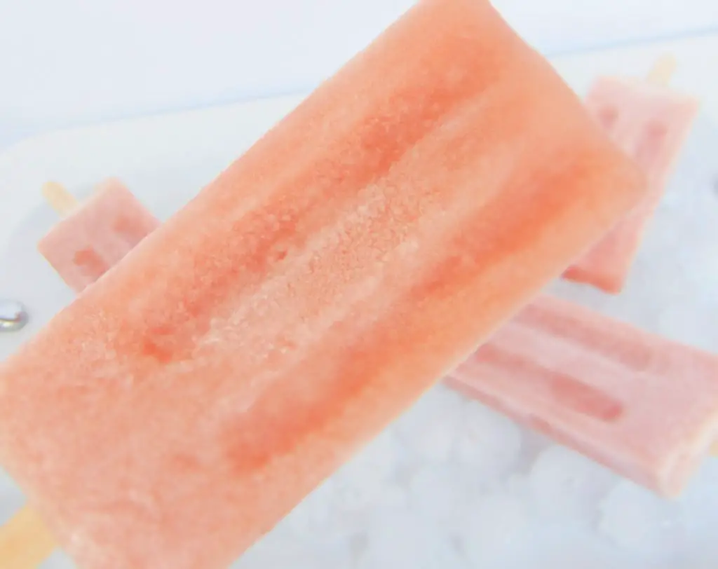 Bone broth popsicle with more popsicles laying on ice in background