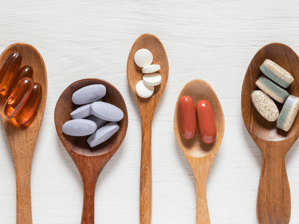Variety of pills on wooden spoons
