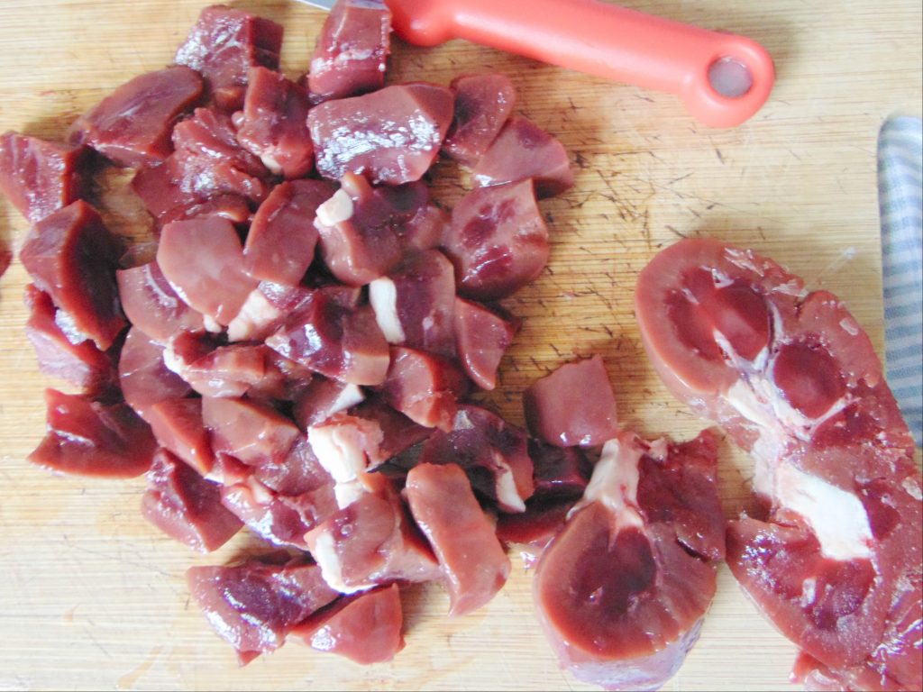 Cutting beef kidney meat on cutting board