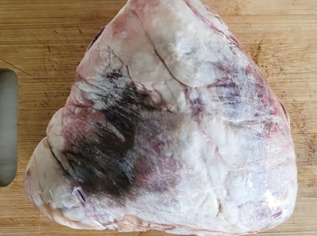 Whole beef heart on cutting board