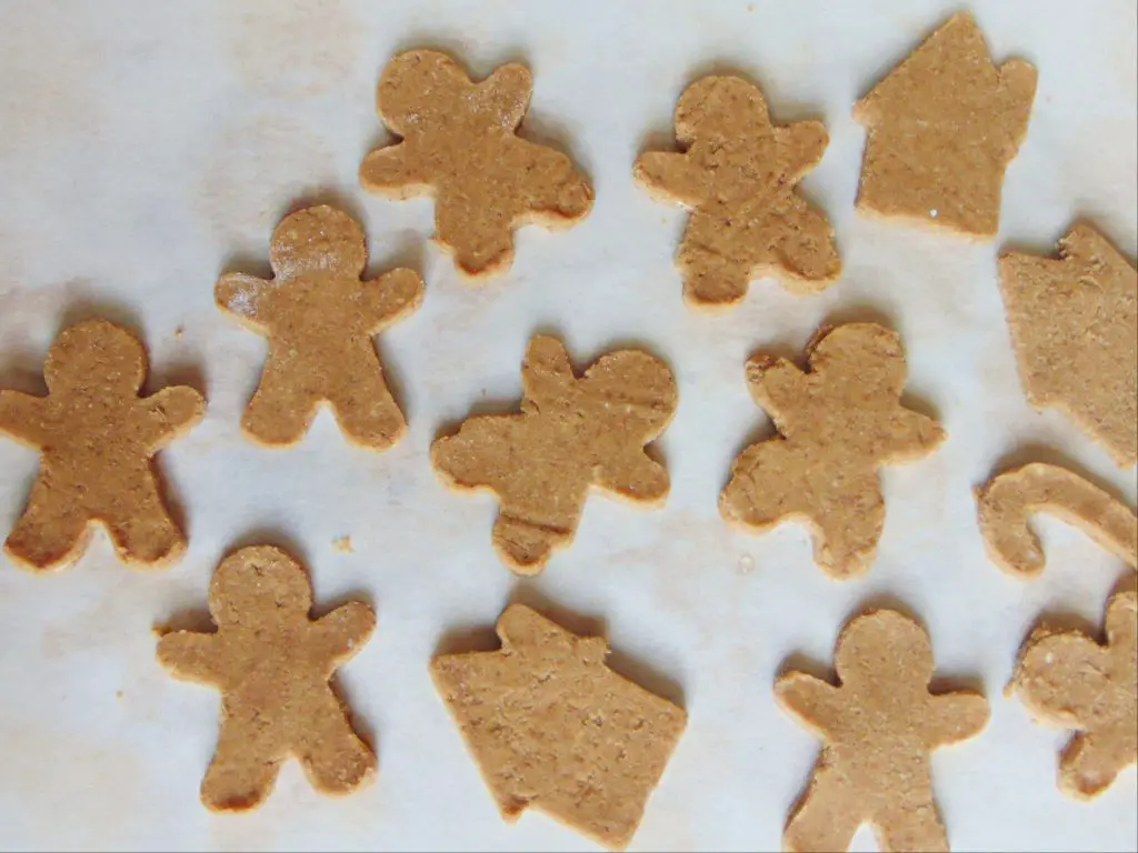 Unbaked coconut flour gingerbread man cookies on parchment paper