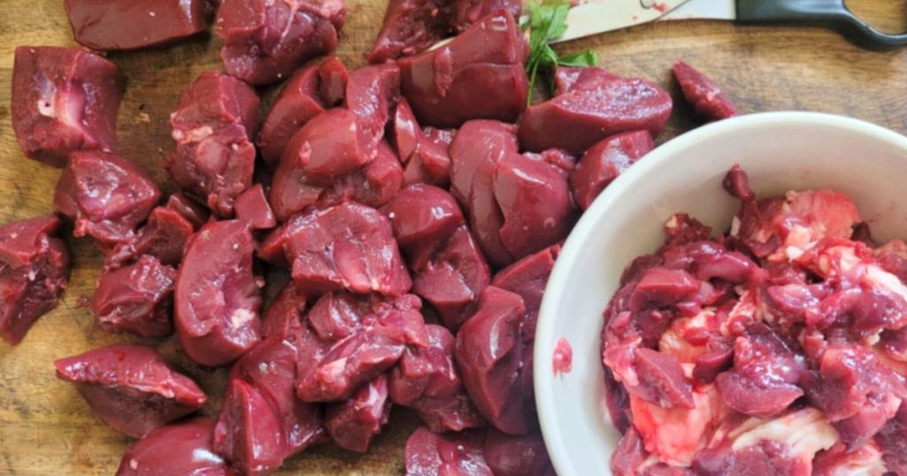 Cleaned and cut beef kidney on cutting board and discard trimmings in a white bowl
