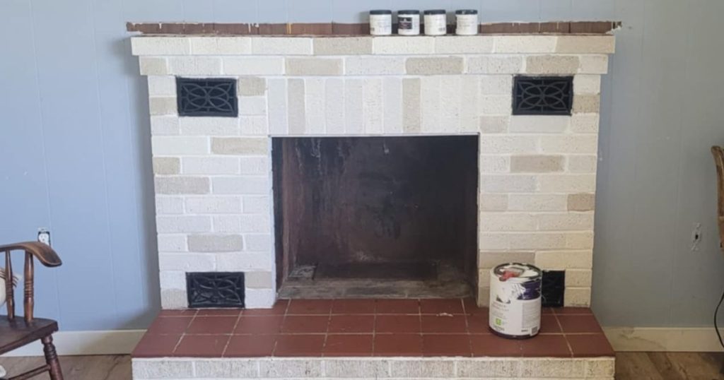 Painting brick fireplace to look like stone using several neutral paint colors.